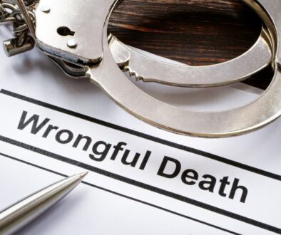 Legal documents on wrongful death with metal handcuffs, justice and law concept.