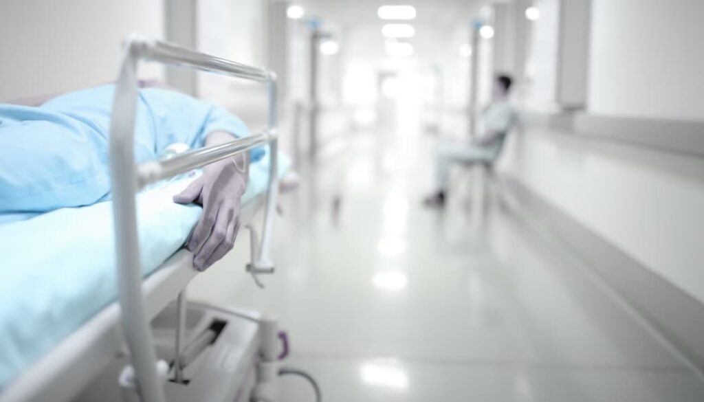 Patient's family waits anxiously in the hospital corridor, grappling with the shadow of death.