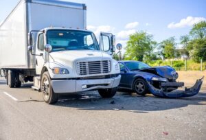 Collision of a truck with a passenger car on the highway road, as a result of which both were damaged.