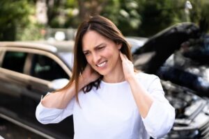 Experiencing whiplash injury and pain after an automobile accident. 