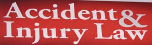 Red sign with white text that says "Accident & Injury Law". Signs like this are typically used by personal injury lawyers to advertise their services.