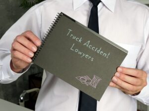 The business idea revolves around Truck Accident Lawyers, as depicted on a piece of paper with corresponding inscriptions.