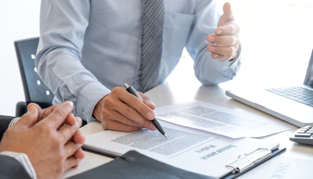 An insurance agent elucidating an insurance policy to a customer.