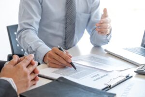 An insurance agent elucidating an insurance policy to a customer. 