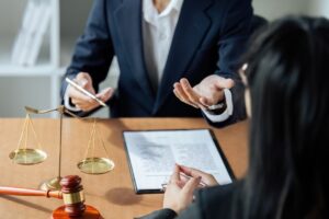 A lawyer or legal advisor discussing contract specifics with a businessperson, detailing agreement terms within business contracts.