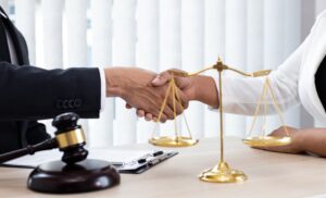 Lawyers or counselors joining hands with clients to celebrate the conclusion of a case, symbolizing the resolution of lawsuits through negotiation or settlement. 