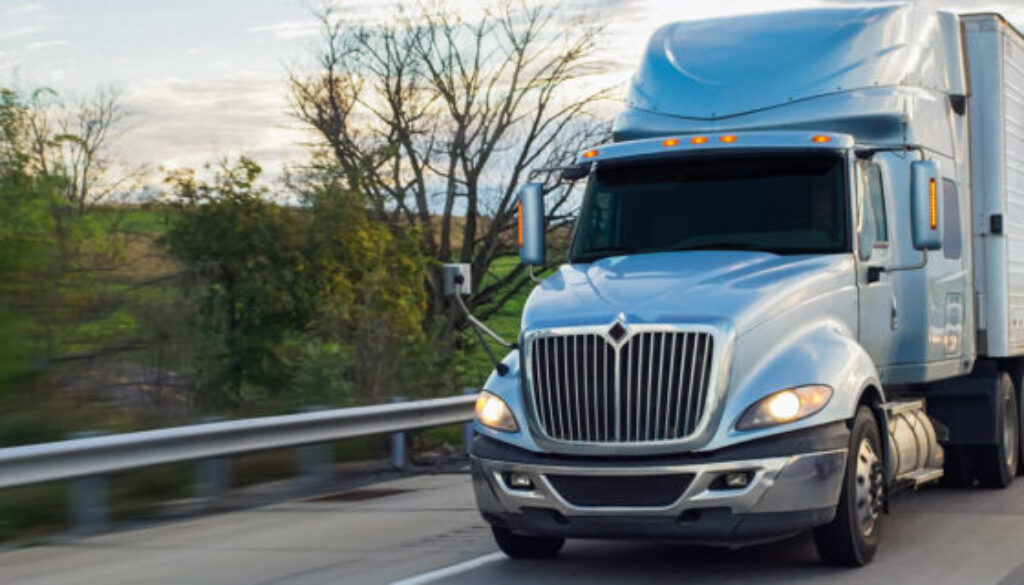 Truck on Oklahoma highway after accident, with cars beside it.