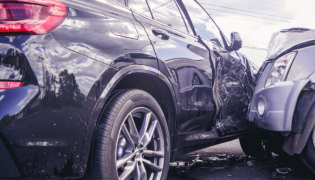 Oklahoma car accident fault scene showing a severe side-impact collision between a black SUV and a silver SUV with visible damage.