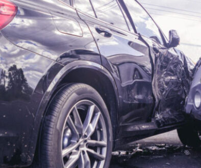 Oklahoma car accident fault scene showing a severe side-impact collision between a black SUV and a silver SUV with visible damage.