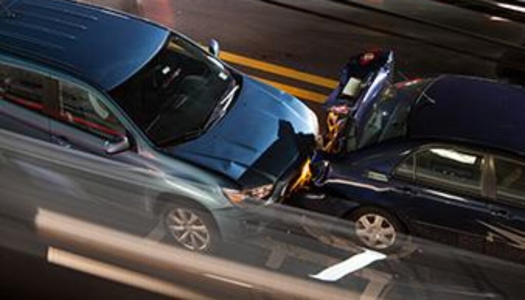Two cars involved in a nighttime rear-end collision on a city street in Oklahoma