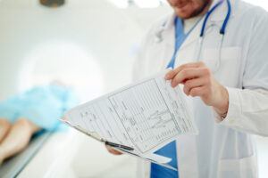 Doctor reviewing patient medical report after accident-related injury.