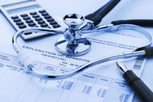 Medical bills and stethoscope after a car accident
