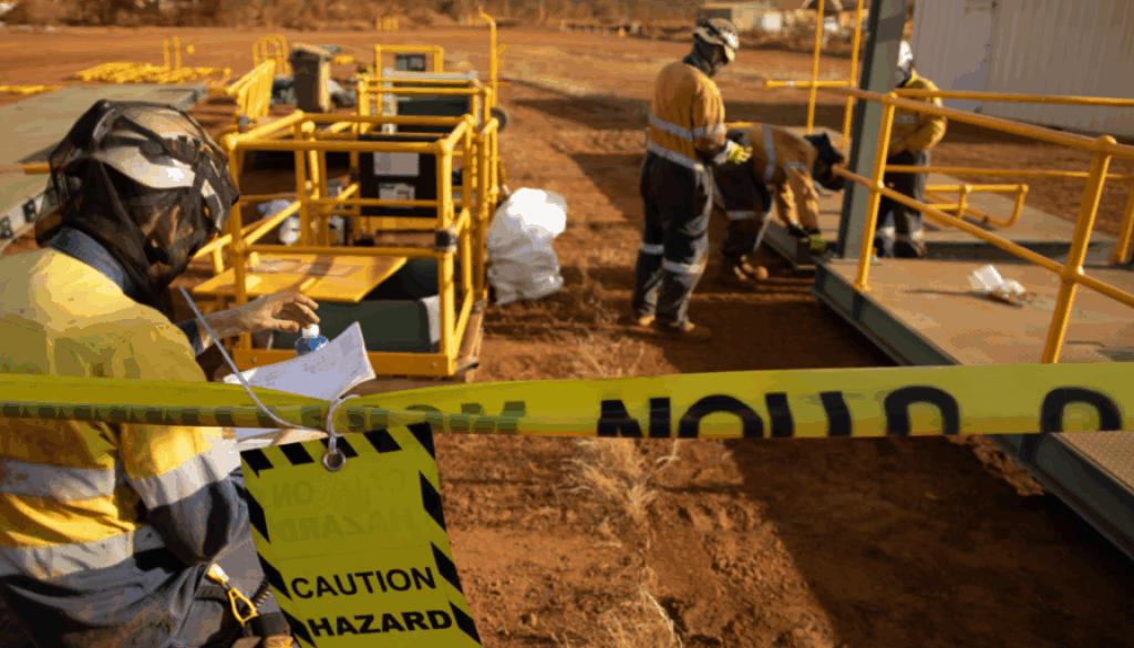 Construction site with caution tape and hazard signage highlighting potential site injuries.