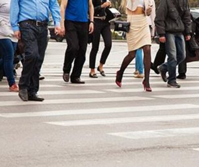 Pedestrians crossing a busy Tulsa street near a crosswalk, used by a Tulsa pedestrian injury attorney to highlight accident risks