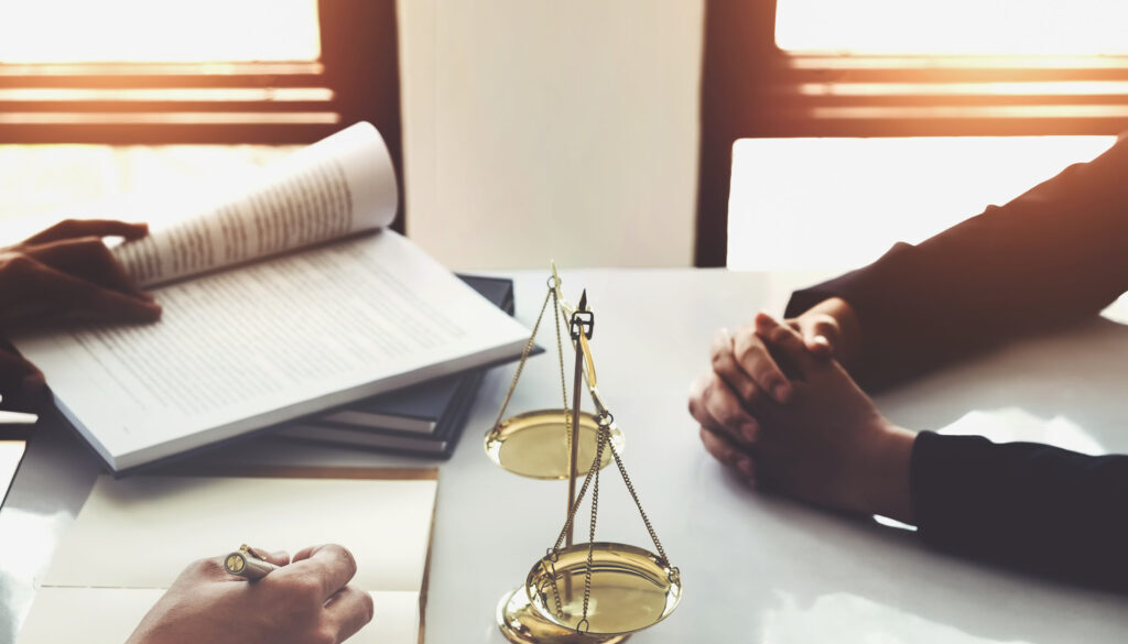 Personal injury lawyer consulting with client at law office table