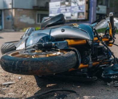 recked motorcycle lying on its side after a serious road accident