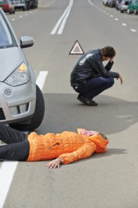 Pedestrian accident scene in Tulsa with driver in distress, reinforcing the need for experienced Tulsa personal injury lawyers.