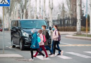 Children using a marked crosswalk in Tulsa school zone, illustrating areas a Tulsa pedestrian injury attorney often investigates