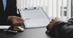 Insurance attorney explaining coverage details to a client in an office.