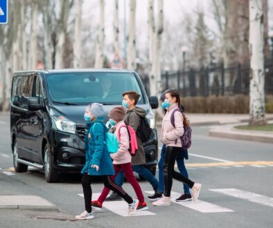 Children crossing at a marked crosswalk while a car yields in a Tulsa school zone