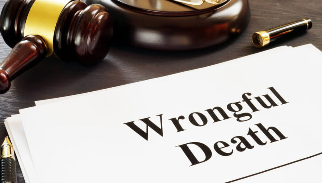 Legal document labeled “Wrongful Death” beside a judge’s gavel and reading glasses on a desk